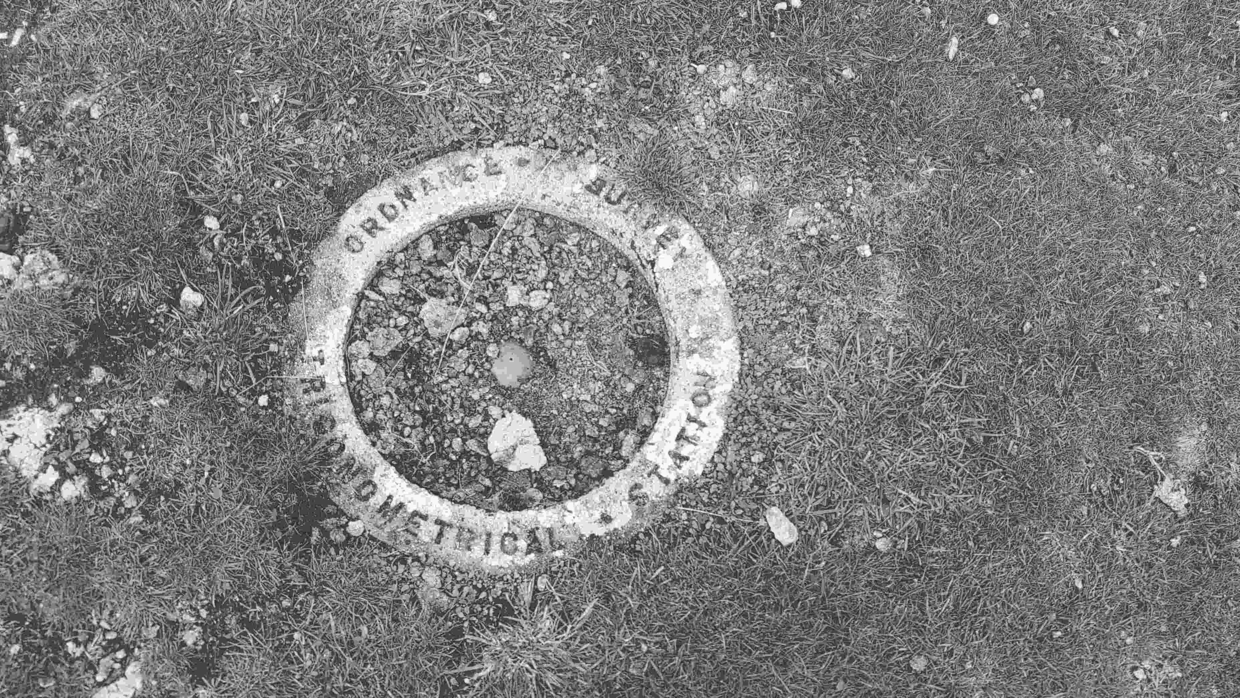 The trig point, a concrete ring in the ground, not the usual white pillar